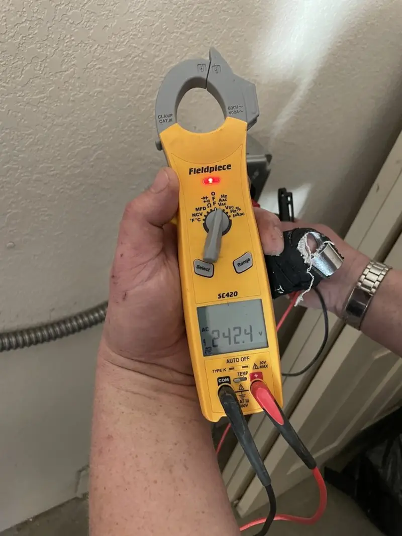 Voltage testing with clamp meter during Ceiling Fan Installation in East Nottingham